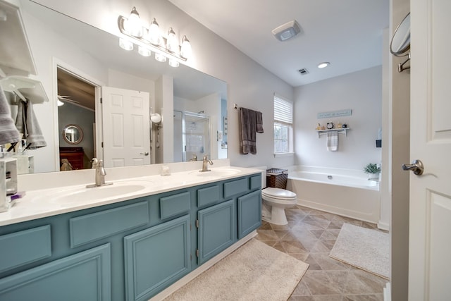 full bathroom featuring toilet, vanity, shower with separate bathtub, and tile patterned flooring