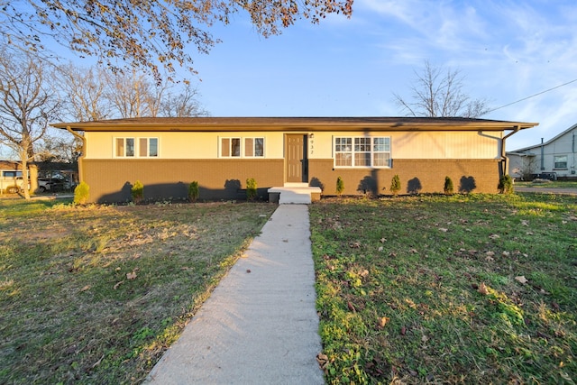 ranch-style home with a front lawn