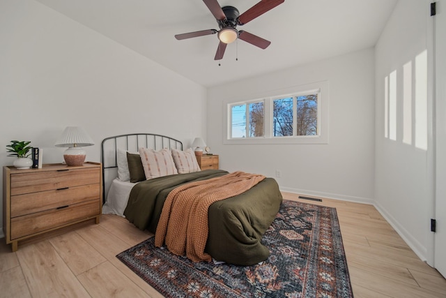 bedroom with ceiling fan and light hardwood / wood-style floors