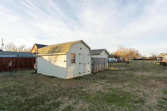 view of outbuilding featuring a lawn