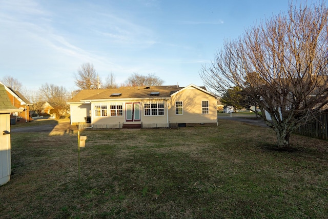 rear view of house with a lawn