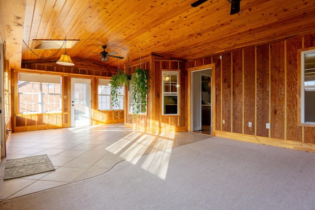 unfurnished room featuring wood ceiling, ceiling fan, lofted ceiling, and light tile patterned flooring