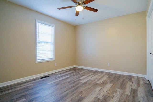 empty room featuring ceiling fan and light hardwood / wood-style flooring