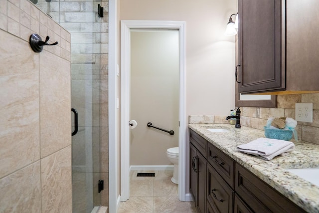 bathroom with walk in shower, vanity, backsplash, and toilet