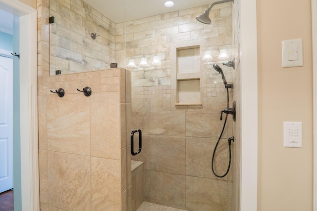 bathroom featuring a shower with shower door