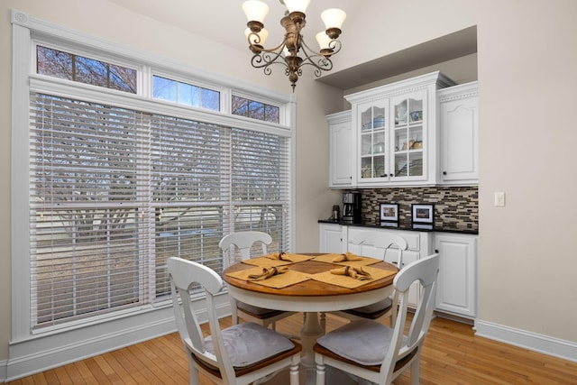 dining room featuring a notable chandelier and light wood-type flooring