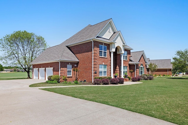 view of front of home with a garage and a front lawn