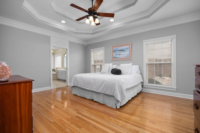 bedroom featuring crown molding, ceiling fan, light hardwood / wood-style floors, and a tray ceiling