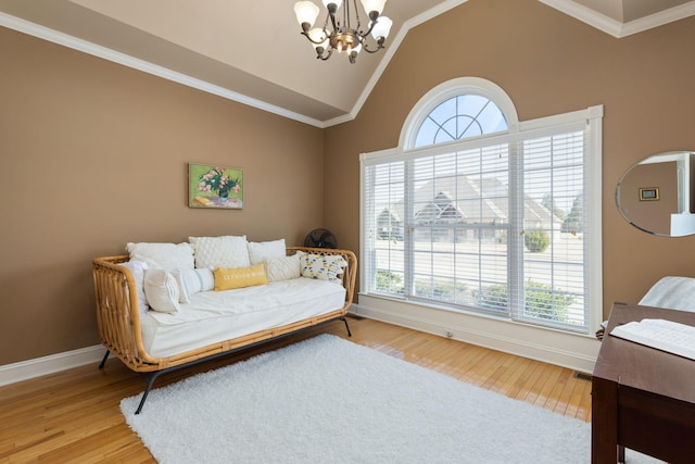 sitting room with hardwood / wood-style flooring, vaulted ceiling, ornamental molding, and a chandelier