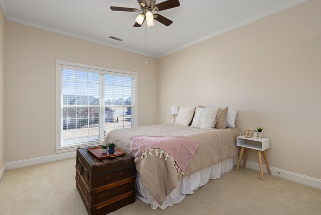 bedroom featuring ornamental molding, light carpet, and ceiling fan