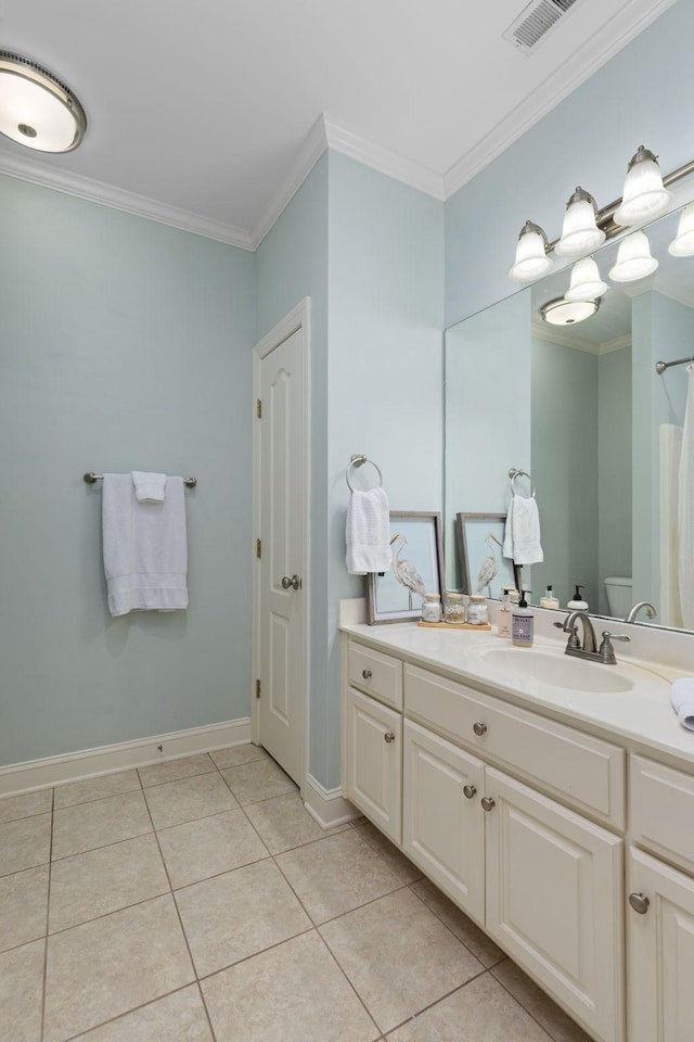 bathroom with vanity, tile patterned floors, ornamental molding, and toilet