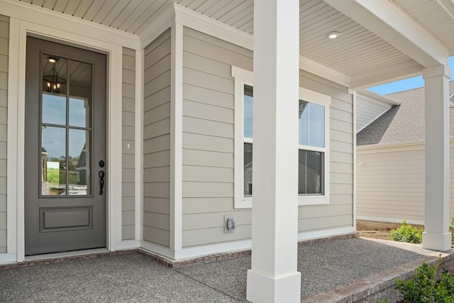 view of exterior entry featuring a porch