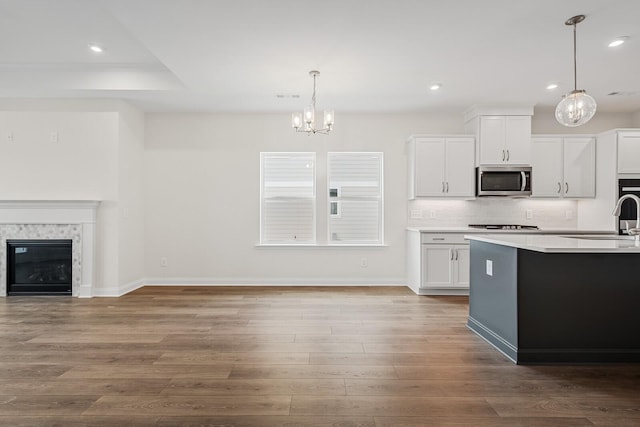 kitchen with pendant lighting, sink, and white cabinets