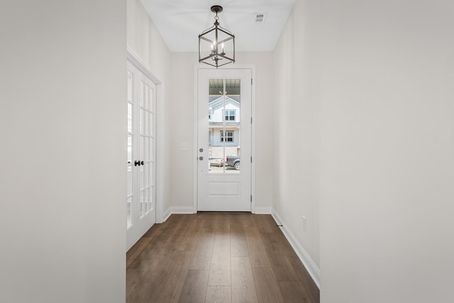 entryway featuring hardwood / wood-style floors and a chandelier