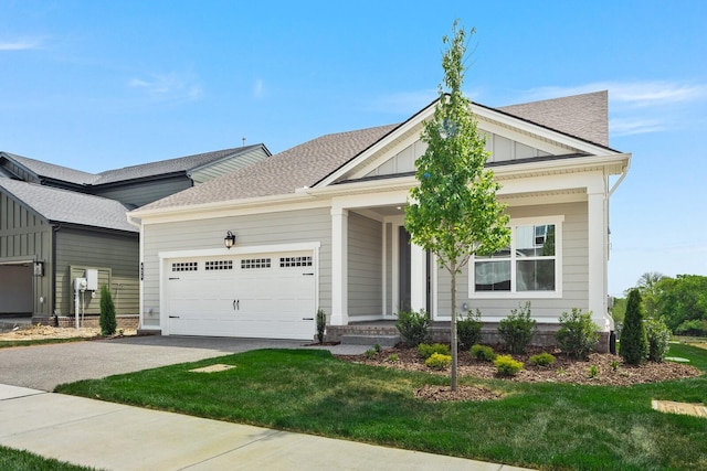 view of front of property featuring a garage and a front lawn