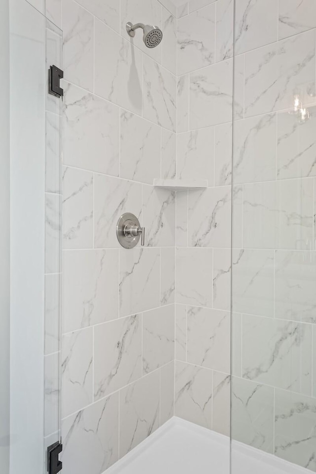 bathroom with a tile shower