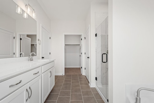 bathroom with vanity, tile patterned floors, and a shower with door