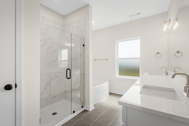 bathroom featuring tile patterned flooring, plus walk in shower, and vanity