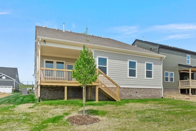 rear view of property with cooling unit and a yard