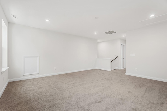 unfurnished room with light colored carpet