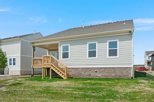 back of property with a wooden deck and a lawn