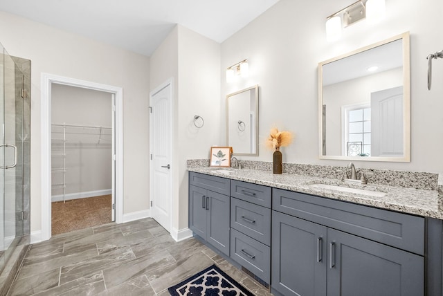 bathroom featuring walk in shower and vanity