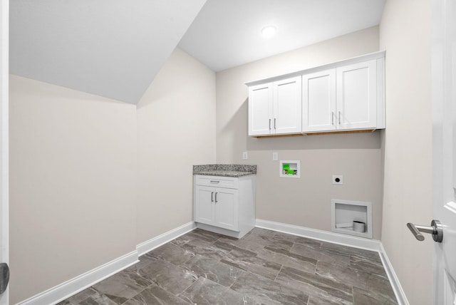 laundry room featuring electric dryer hookup, hookup for a washing machine, and cabinets