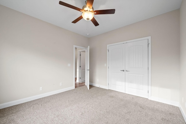 unfurnished bedroom featuring carpet floors, ceiling fan, and a closet