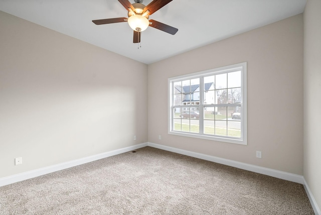 spare room with carpet floors and ceiling fan