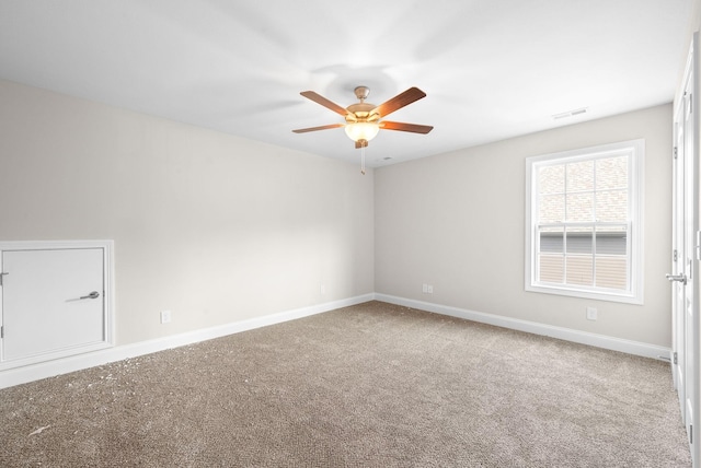 spare room with ceiling fan and carpet