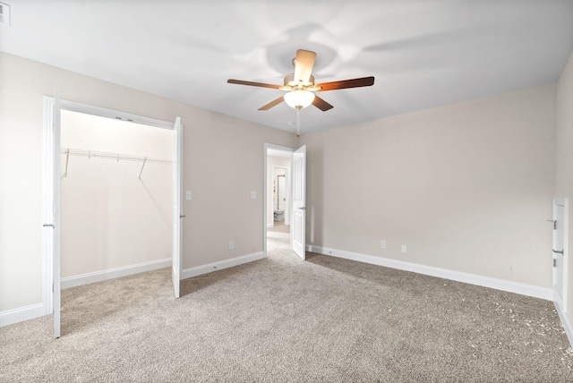 unfurnished bedroom with carpet flooring, ceiling fan, and a closet