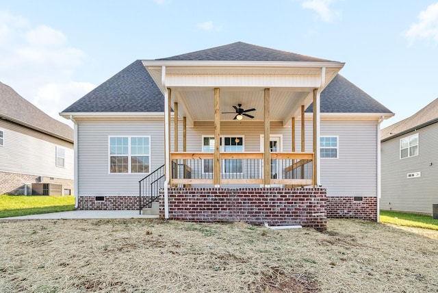 rear view of property with covered porch, ceiling fan, and a patio area