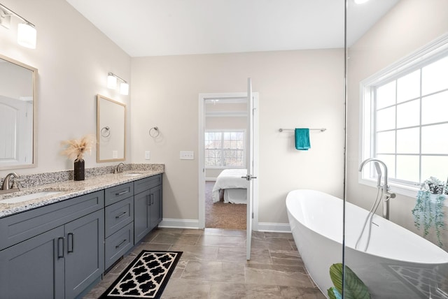 bathroom with vanity and a washtub