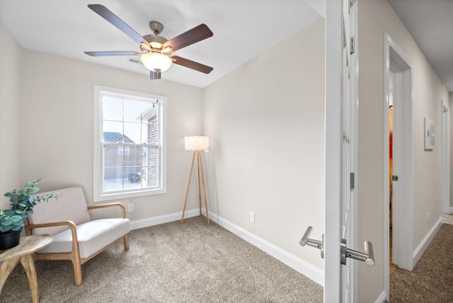 living area with carpet floors and ceiling fan