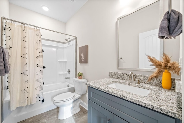 full bathroom with vanity, shower / bath combination with curtain, and toilet