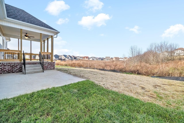 view of yard with a patio area and ceiling fan