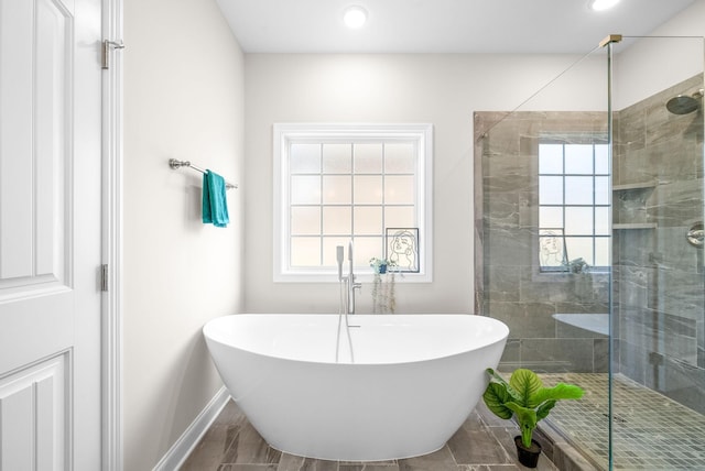 bathroom featuring shower with separate bathtub and a wealth of natural light