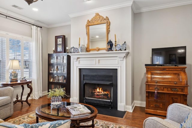 sitting room with ornamental molding and dark hardwood / wood-style flooring