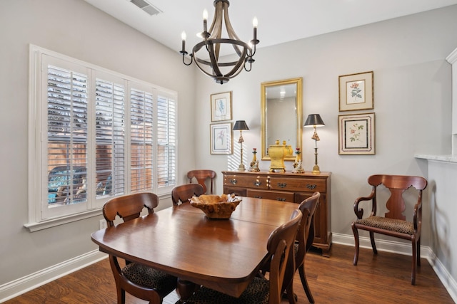 dining room featuring dark hardwood / wood-style floors and a chandelier