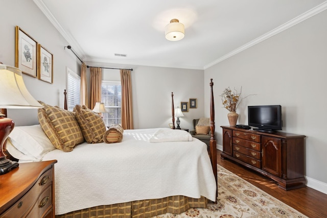 bedroom with ornamental molding and dark hardwood / wood-style floors