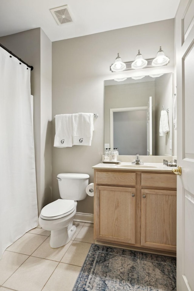 bathroom with vanity, tile patterned floors, and toilet