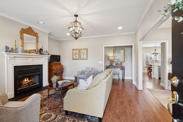 living room with dark hardwood / wood-style flooring, a notable chandelier, and crown molding