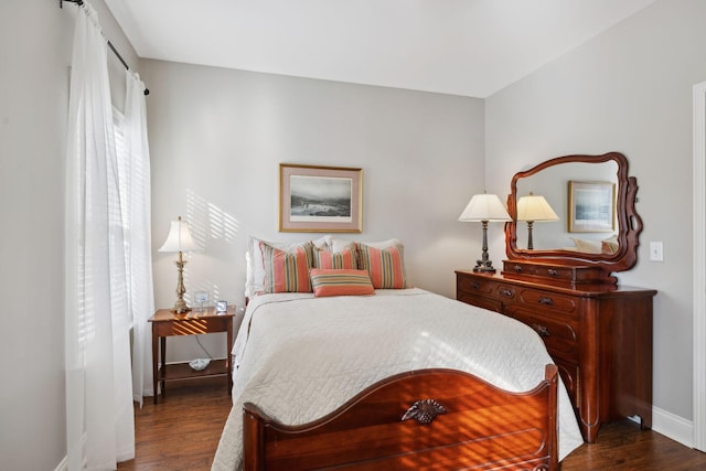 bedroom with dark hardwood / wood-style flooring