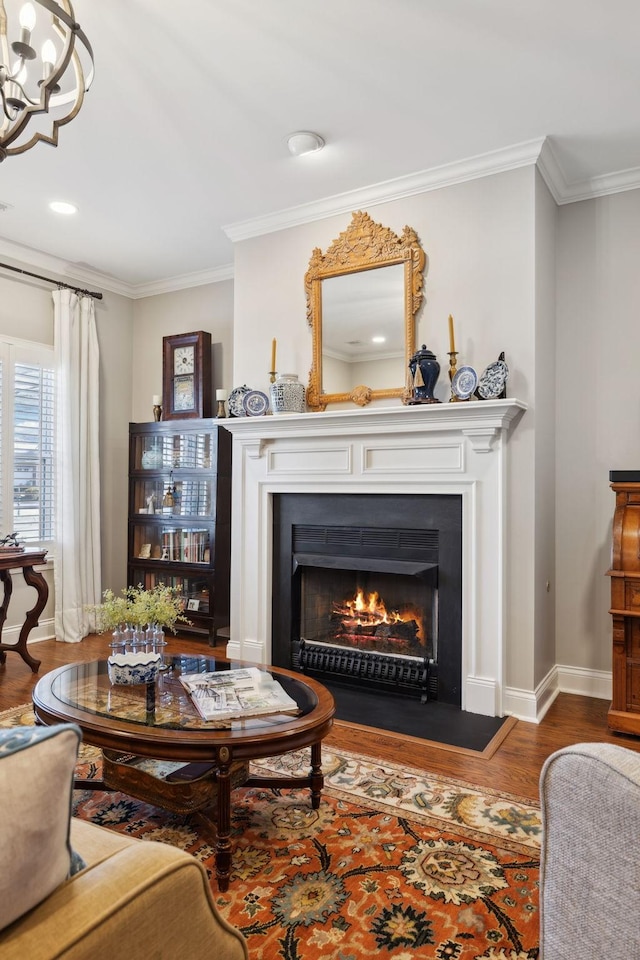 living area featuring crown molding, dark wood-type flooring, and a notable chandelier