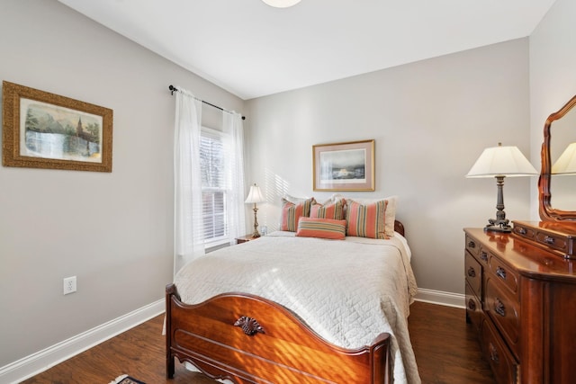 bedroom with dark hardwood / wood-style floors