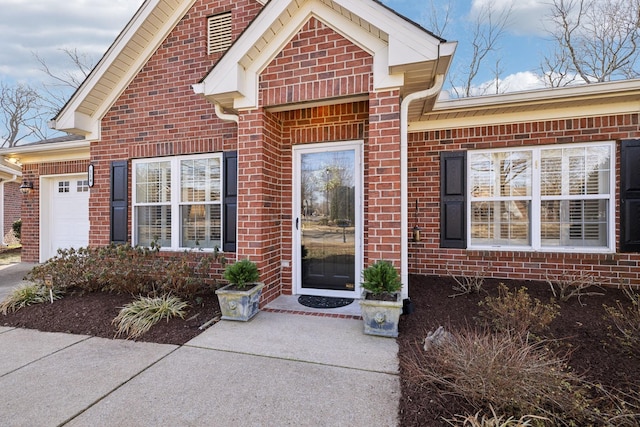 view of exterior entry with a garage