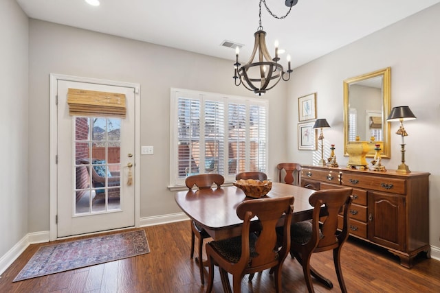 dining space featuring plenty of natural light, dark hardwood / wood-style floors, and a chandelier