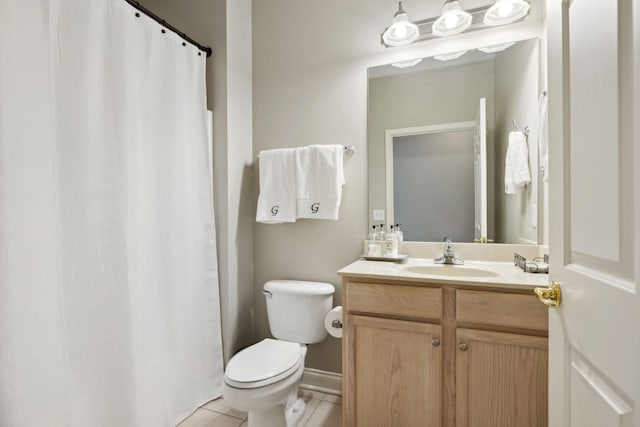 bathroom featuring tile patterned flooring, vanity, and toilet