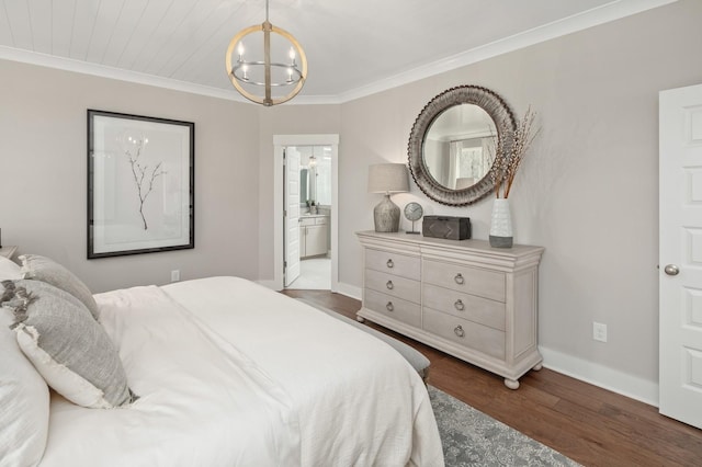 bedroom with ensuite bath, ornamental molding, dark hardwood / wood-style floors, and a notable chandelier