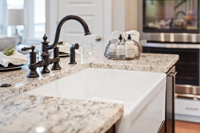 details featuring stainless steel oven, oven, and sink